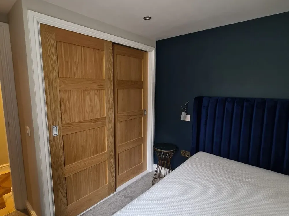 Fitted sliding oak wardrobes built by Abbey Group