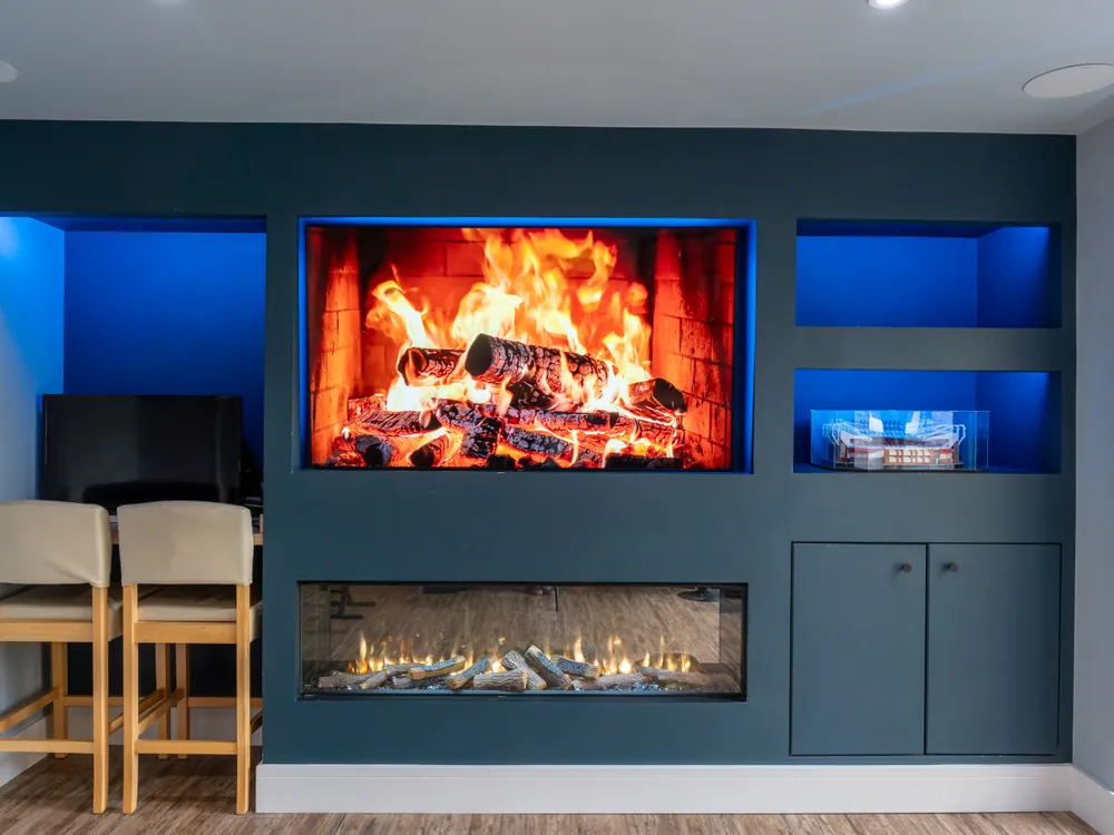 Fitted media wall with cabinetry and lit alcoves built by Abbey Group