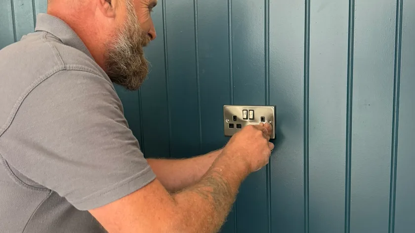 Abbey Group electrician wiring a socket in a Whitby home