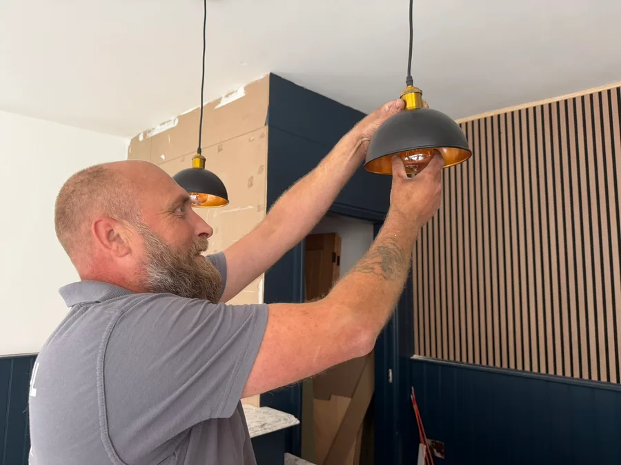 Abbey Group electrician fitting a pendant light in a Whitby home